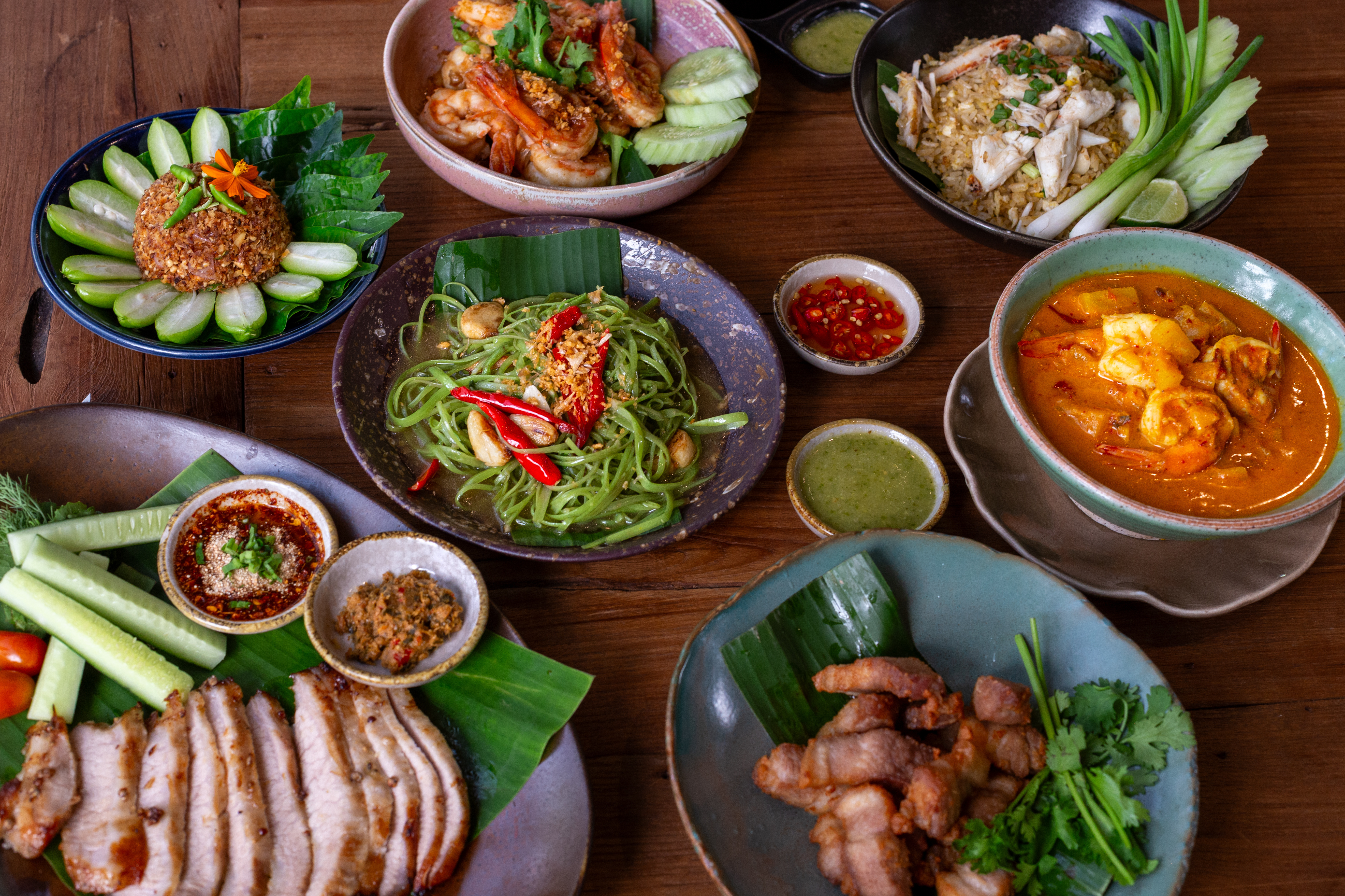 A flat-lay spread of Thai dishes served at Natura Cafe, Poomjai Garden.