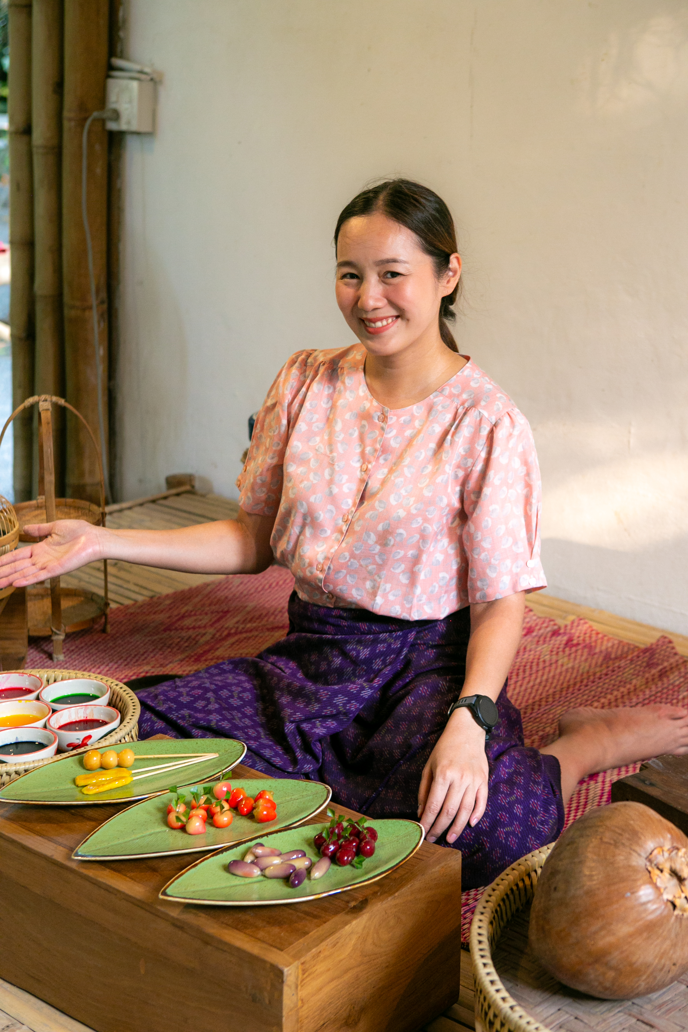 A host presenting a tray of dye bowls and finished look choup fruit shapes.
