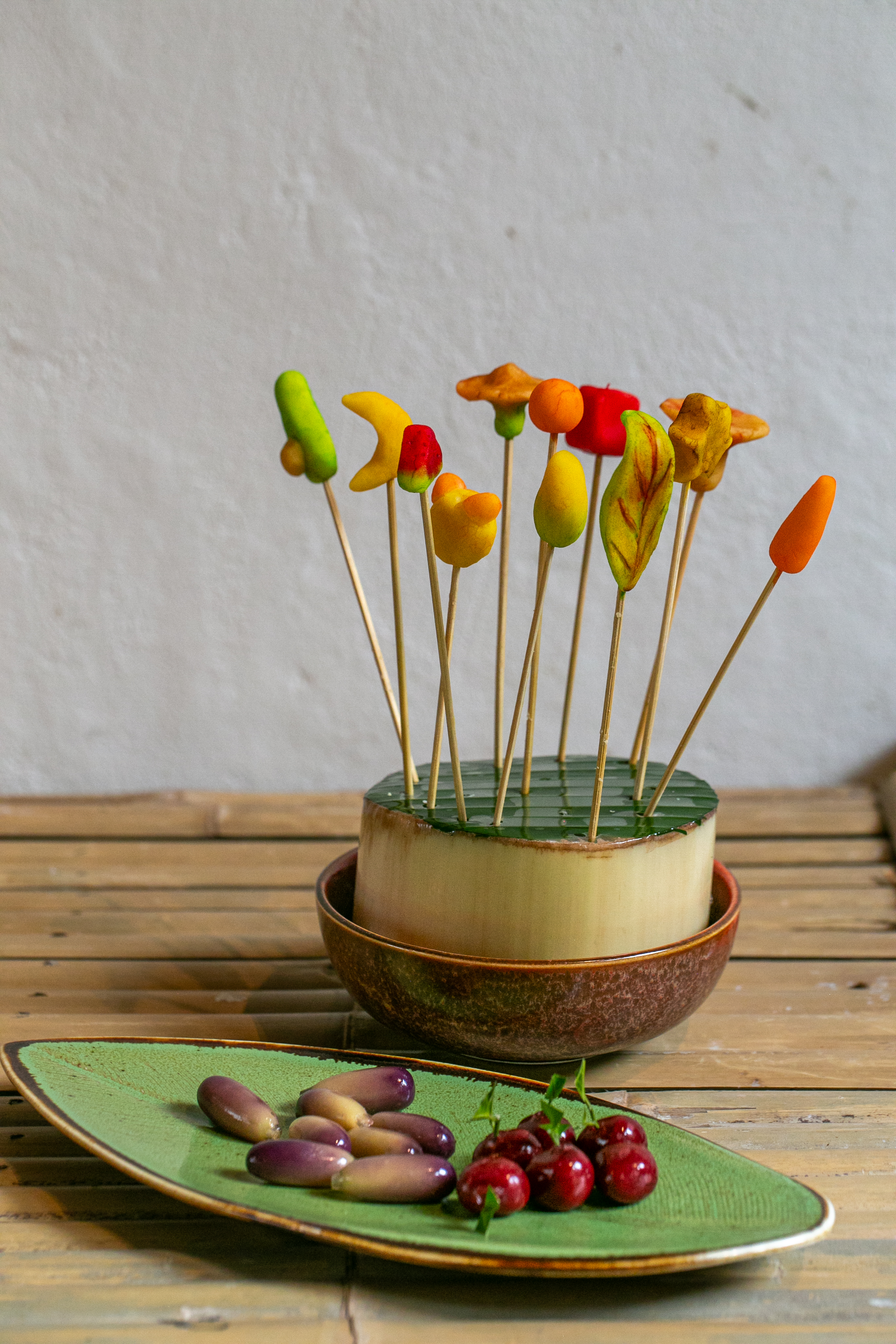 Several guests dipping dessert dumplings into bowls of natural dye together.